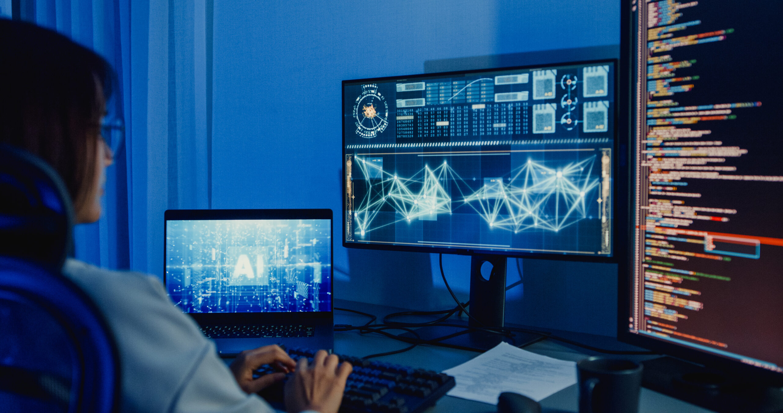 Young Asian woman software developers using computer to write code application program for AI technology at desk with multiple screens work at home office night. Programmer development.